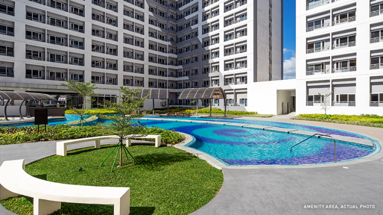 Blue pools by buildings in grace residences