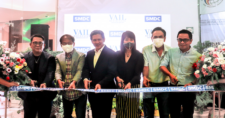 People Cutting a Ribbon in SMDC Vail Showroom